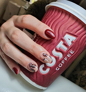 close-up-of-hand-holding-a-costa-coffee-cup